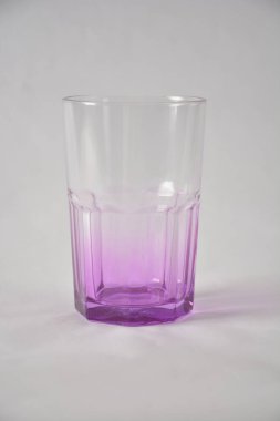 Transparent glass with a gradient purple base on a white background. clipart