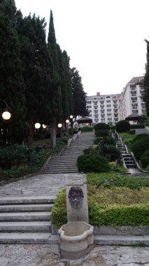 Yeşillik ve fenerlerle dolu zarif taş bir yol..