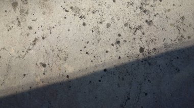 Benekli ve gölgeli desenli beton yüzey.