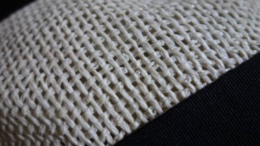Kumaş yüzeyindeki dokuma deseninin yakın plan görüntüsü.