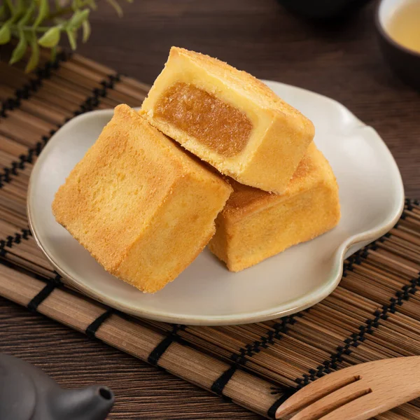 stock image Delicious Taiwanese pineapple cake pastry dessert in a plate on wooden table background with hot tea.