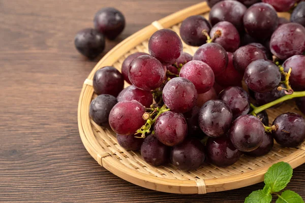 Delicious Bunch Purple Grapes Fruit Tray Wooden Table Background Royalty Free Stock Photos