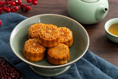 Delicious Cantonese moon cake for Mid-Autumn Festival food mooncake on wooden table background for afternoon tea, holiday celebration serving.