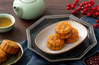 Delicious Cantonese moon cake for Mid-Autumn Festival food mooncake on wooden table background for afternoon tea, holiday celebration serving.