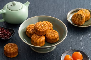 Delicious Cantonese moon cake for Mid-Autumn Festival food mooncake on blue table background for afternoon tea, holiday celebration serving.