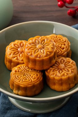 Delicious Cantonese moon cake for Mid-Autumn Festival food mooncake on wooden table background for afternoon tea, holiday celebration serving.