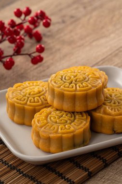Delicious Cantonese moon cake for Mid-Autumn Festival food mooncake on wooden table background for afternoon tea, holiday celebration serving.