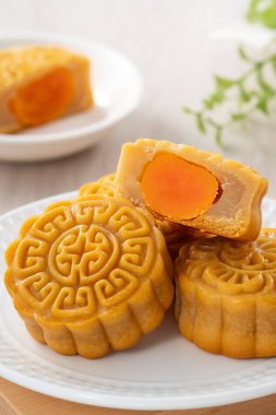 Delicious Cantonese moon cake for Mid-Autumn Festival food mooncake on wooden table background for afternoon tea, holiday celebration serving.