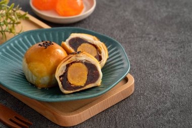 Design concept of Moon cake yolk pastry, mooncake for Mid-Autumn Festival holiday on dark gray table background