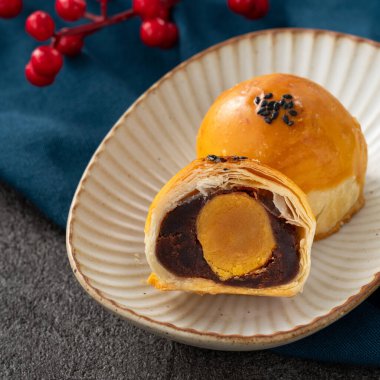 Design concept of Moon cake yolk pastry, mooncake for Mid-Autumn Festival holiday on dark gray table background