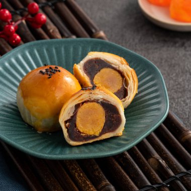 Design concept of Moon cake yolk pastry, mooncake for Mid-Autumn Festival holiday on dark gray table background