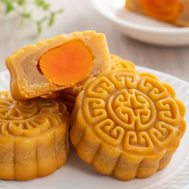 Delicious Cantonese moon cake for Mid-Autumn Festival food mooncake on wooden table background for afternoon tea, holiday celebration serving.