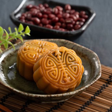 Delicious Cantonese moon cake for Mid-Autumn Festival food mooncake on blue table background for afternoon tea, holiday celebration serving.