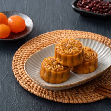 Delicious Cantonese moon cake for Mid-Autumn Festival food mooncake on blue table background for afternoon tea, holiday celebration serving.