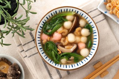 Ev yapımı kırmızı-beyaz tangyuan, tang yuan, glutinous pirinç köftesi ve beyaz arka planda lezzetli bir çorba..