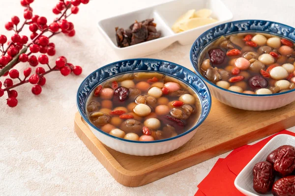 Little homemade red and white tangyuan, tang yuan, rice dumpling balls, with sweet syrup soup and dried longan pulp for Winter solstice festival.
