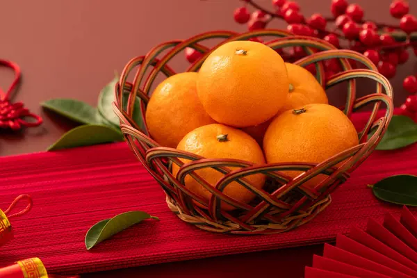 Chinese lunar new year background with fresh tangerine, red envelope, paper fan and decorations for Spring Festival.