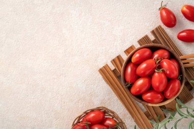 Top view of fresh cherry tomatoes over white table background
