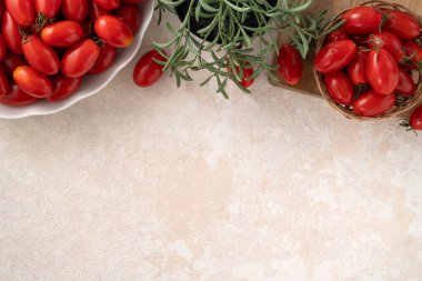Top view of fresh cherry tomatoes over white table background
