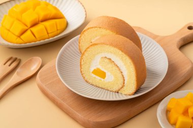 Lezzetli mango kremalı İsviçre usulü kek taze mango küpleriyle servis edilir..