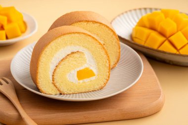 Lezzetli mango kremalı İsviçre usulü kek taze mango küpleriyle servis edilir..