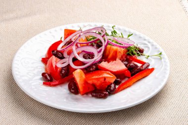 Vegetable salad with tomatoes, beans and onions. 