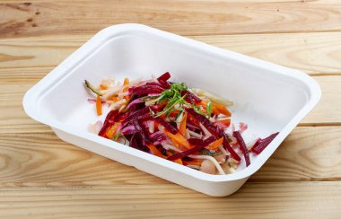 Vinigret salatası. Vejetaryen yemeği. Paket yemek. Ahşap bir arka planda.