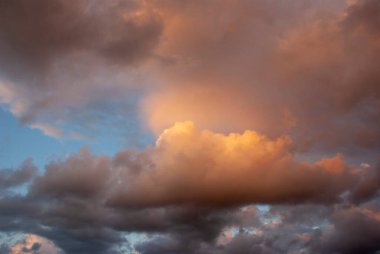 Sky threatening rain and sunshine passing through the clouds. Dark sky and black clouds before rainy, Dramatic black cloud and thunderstorm. The dark sky with heavy clouds converging and a violent storm before the rain.Bad or moody weather sky.