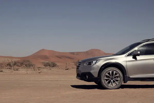 stock image Grey Subaru in the sand of the Namib desert against the bright sky