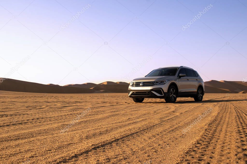 Volkswagen Tiguan allspace in the sand of the Namib desert at a bright sky. Walvis Bay, Namibia.