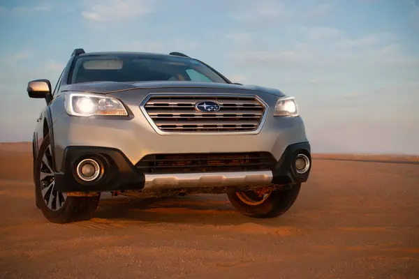 stock image Grey Subaru in the sand of the Namib desert against a bright sky.  Namibia.