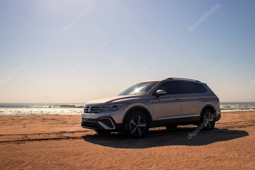 Volkswagen Tiguan allspace in the sands of the Namib Desert on the shores of the Atlantic Ocean on a sunny day