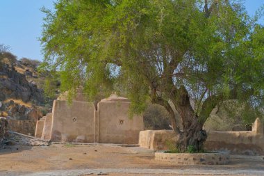 Popular touristic place in North Emirates, Al Bidyah Mosque or Badiyah, or Bidia is oldest worship and heritage religious complex 1446 in UAE. clipart