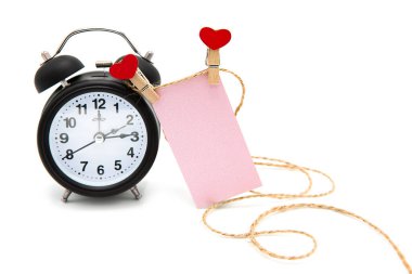Retro alarm clock and greeting blank card with hearts on clothespins on a rope isolated on white background. Time for love.