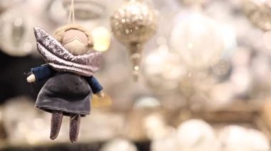 Viyana 'da hareketli bir Noel pazarının canlı atmosferinde zarif bir şekilde asılı duran el yapımı bir süs, kış kutlamalarının ve mutluluğun neşeli ruhunu yakalıyor.