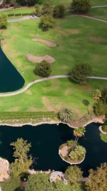 Hava aracı Kaliforniya 'daki pitoresk bir golf sahasının çarpıcı bir görüntüsünü yakalıyor, canlı yeşiller ve dingin gölcüklerle, golfçülere oyundan zevk almaları için mükemmel bir doğal ortam sunuyor.