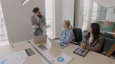 Çok yetenekli profesyonellerden oluşan çeşitli gruplar, modern ofis ortamında verimli bir toplantı yaparak etkili bir işbirliği, yenilikçi fikirler ve takım çalışması sergilemektedirler.