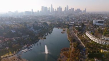 Bu hava manzarası, Los Angeles 'ın canlı şehir merkezinin ufuk çizgisini ve yemyeşil göllerle çevrili sakin Echo Park gölünü gösteriyor. Keşif ve rahatlama için çarpıcı bir şehir vahası yaratıyor.