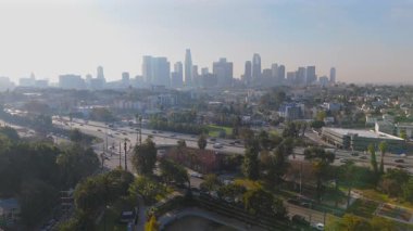 Los Angeles şehir merkezinin hava manzarası ikonik ufuk çizgisini, karmaşık yolları ve çevreleyen yeşil manzaraları sergiliyor. Hepsi de Echo Park bölgesinden güzel bir şekilde izleniyor.
