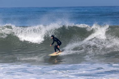 Çok yetenekli bir sörfçü, büyük ve güçlü bir dalgayı güneşin altında ustalıkla sürüyor. Uçsuz bucaksız okyanusta bulunan en büyük özgürlük duygusunu yakalarken sörfün heyecanını gösteriyor.
