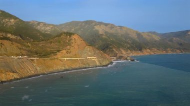 Kaliforniya 'nın çarpıcı Big Sur sahilinin nefes kesici, nefes kesici hava manzarasını tecrübe edin. Muhteşem bir günbatımında hem cennet kıyı şeridini hem de 1. Otoyol' u göstermektedir.