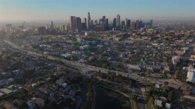 Göz kamaştırıcı hava aracı görüntüleri canlı bir şekilde Echo Park Gölü 'nü ve Los Angeles şehir merkezinin ikonik siluetini gösteriyor. Sabahın erken saatlerindeki hafif ışıkla aydınlatılıyor.