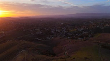Los Angeles Malibu dağlarının çarpıcı insansız hava aracı çekimleri altın saat boyunca gür tepeleri ve gizemli sisi vurguluyor, dingin bir atmosfer yaratan canlı gökyüzü renkleriyle tanınıyor.