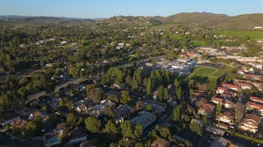 Çarpıcı insansız hava aracı videosu Los Angeles 'ın güzel banliyö manzarasını canlı yeşil tepeler, büyüleyici evler ve hareketli otobanlar sergiliyor. Hepsi de gün batımının ılık renkleriyle yıkanmış.