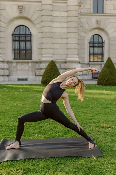Midadlı bir kadın, doğanın huzurunu kucaklarken esneklik ve sükunetin faydalarından tamamen yararlanarak şaşırtıcı derecede güzel doğal bir yerde yoga yapıyor.