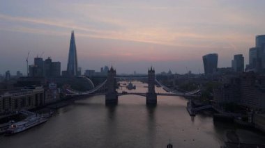 Muhteşem bir insansız hava aracı, sakin Thames nehri tarafından çerçevelenmiş Tower Köprüsü ve Londra ufuk çizgisini yakalıyor. Bu manzara, gezginler için büyüleyici bir yer haline getirerek şehrin cazibesini ön plana çıkarıyor.