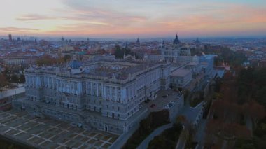 Madrid Kraliyet Sarayı ve Almudena Katedrali 'nin canlı bir şehir manzarasına karşı çarpıcı mimarisini vurgulayarak büyüleyici bir görsel deneyim yaratıyor.