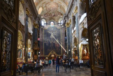 Ukraine Lviv April 28, 2023 interior decoration of the church view of the altar from the side of the passage between the rows of benches. clipart