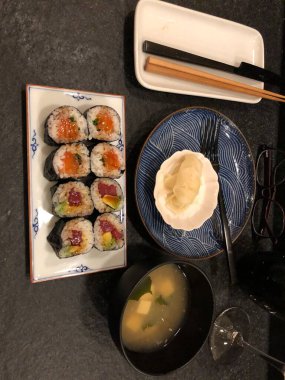 Geleneksel Japon Tabağı 'nda servis edilen ton balığı, somon, avokado ve soya soslu suşi ruloları..
