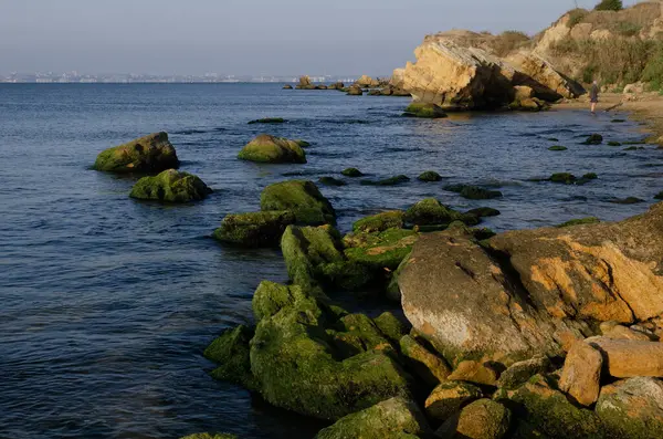 İçlerinde açık denizle akan kayaların olduğu deniz kıyısı..